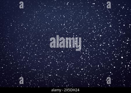 Natural snow particles in the air. Dark blue fading to black background. High quality photo Stock Photo