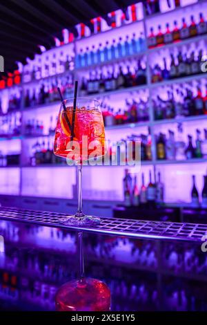 Alcoholic cocktail with ice and a piece of orange on the bar counter Stock Photo