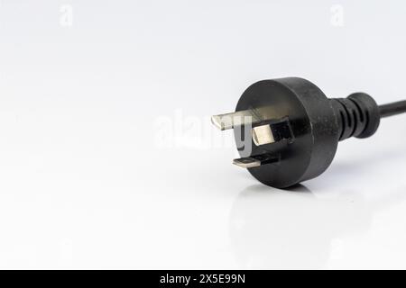 Electric plug with three pins isolated on a white background Stock Photo