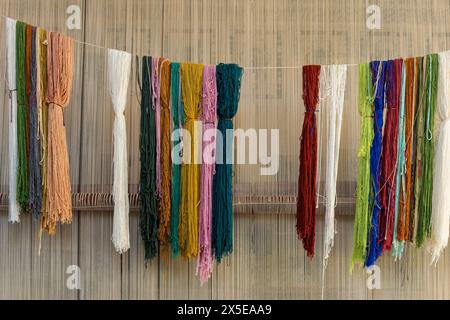 Egyptian Carpet School in Saqqara, Egypt. Dyed wool yarn hangs in the studio. Stock Photo