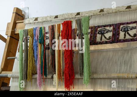 Egyptian Carpet School in Saqqara, Egypt. Dyed wool yarn hangs in the studio. Stock Photo