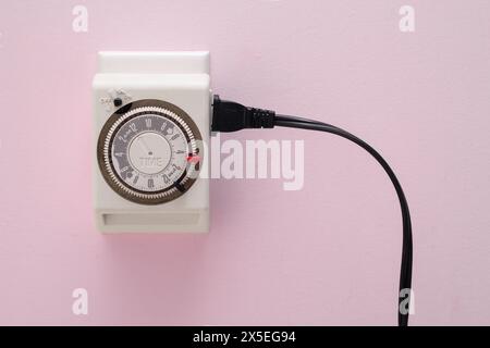 Electrical outlet timer and power cord Stock Photo