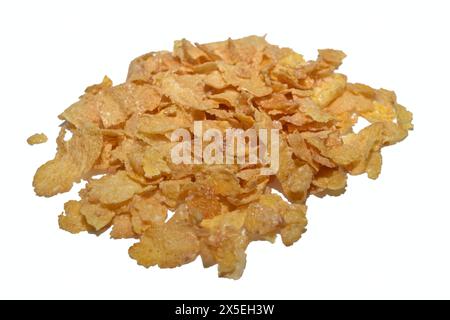 Corn flakes for a delicious breakfast lie on a white background. Stock Photo