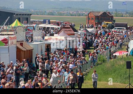 Ballenstedt, Germany. 09th May, 2024. Visitors stand on the airfield at Ballenstedt airfield. The airfield hosted an open day on Ascension Day. Thousands of visitors experienced flight demonstrations and parachute jumps by participating pilots throughout the day. Credit: Matthias Bein/dpa/ZB/dpa/Alamy Live News Stock Photo