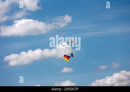 Ballenstedt, Germany. 09th May, 2024. Parachutists are dropped over Ballenstedt airfield. The airfield hosted an open day on Ascension Day. Thousands of visitors experienced flight demonstrations and parachute jumps by participating pilots throughout the day. Credit: Matthias Bein/dpa/ZB/dpa/Alamy Live News Stock Photo