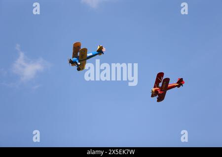 Ballenstedt, Germany. 09th May, 2024. Two biplanes fly in formation. The commercial airfield in Ballenstedt hosted an open day on Ascension Day. Thousands of visitors experienced flight demonstrations and parachute jumps by participating pilots throughout the day. Credit: Matthias Bein/dpa/ZB/dpa/Alamy Live News Stock Photo