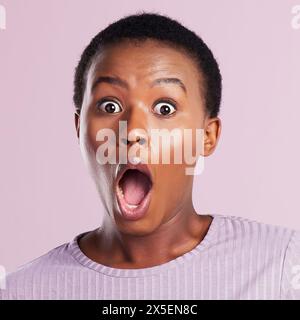 Portrait, surprise or black woman with shock, wow or scared expression for gossip news or studio sale. Pink background, open mouth or African girl in Stock Photo