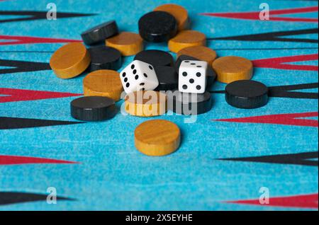 Checkers and dices on a backgammon board Stock Photo