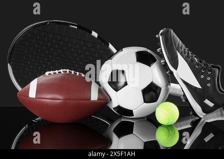 Many different sports equipment on black mirror surface Stock Photo