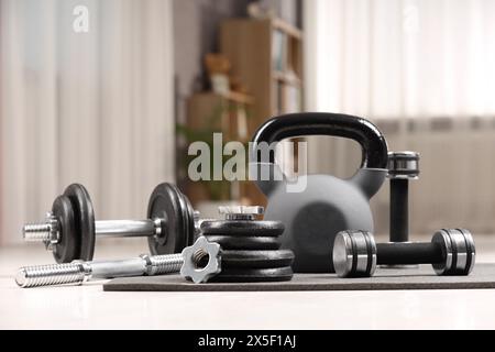 Many different sports equipment on floor indoors Stock Photo