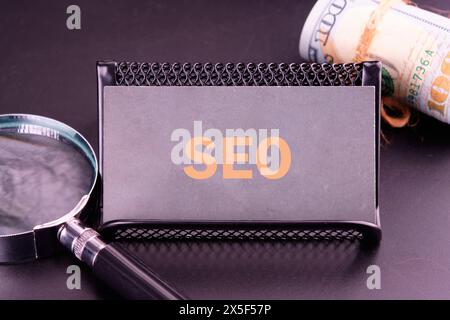 SEO business, SEO concept. Search engine optimization text on a gray business card in golden letters Stock Photo