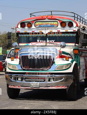 'Chicken Bus'. Antigua, Guatemala. Refurbished retired U.S. school bus in the bus station next to the Municipal Market. Vivid, individualised, famed. Stock Photo