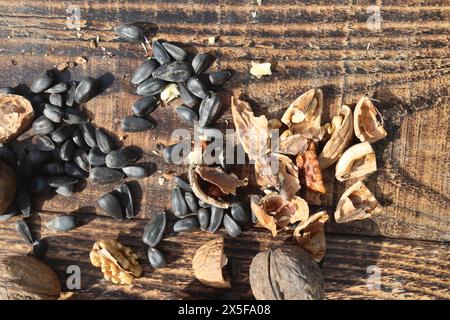Composition with walnuts and seeds on wooden background, top view Stock Photo