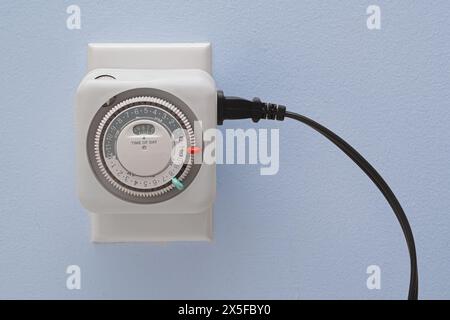 Electrical outlet timer and power cord Stock Photo