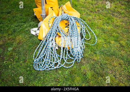 blue climbing rope on green grass .  background image of the rope for active sports. Stock Photo