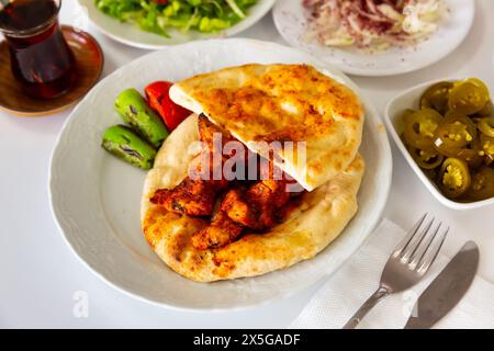 Turkish chicken shish kebab on pita bread with vegetables Stock Photo