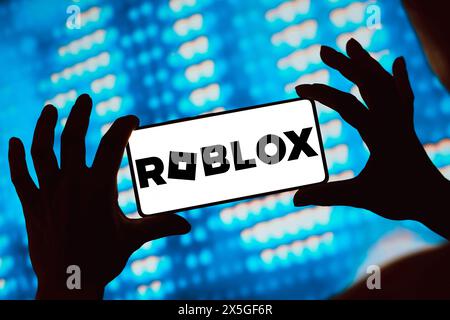 In this photo illustration, the Roblox logo is displayed on a smartphone screen. Stock Photo