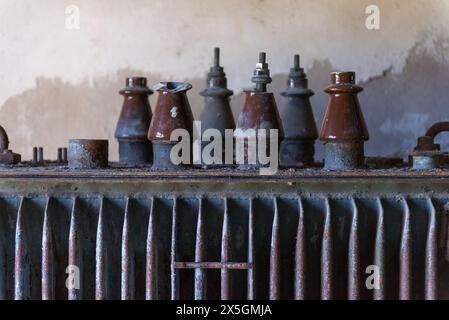 A row of old, rusted metal objects sit on a table. The objects are all different shapes and sizes, but they all have a similar, worn appearance. Scene Stock Photo