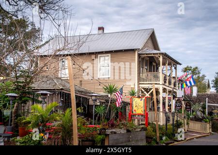 Historic pedestrian street with the Bull & Crown Publick House and colonial-era wooden buildings at sunset in St. Augustine, Florida Stock Photo