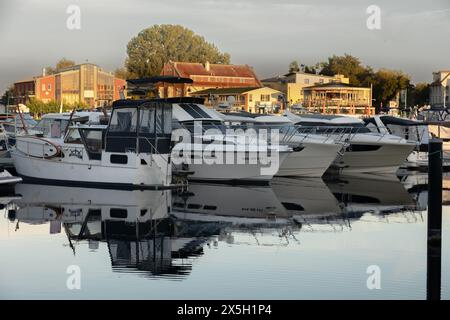 Waren an der Muritz, Germany - August 10, 2022: yachts in the local marina and harbor buildings in the background Stock Photo