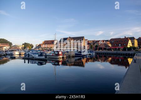 Waren an der Muritz, Germany - August 10, 2022: view at yachts in the local marina and old buildings in the city of Waren Stock Photo