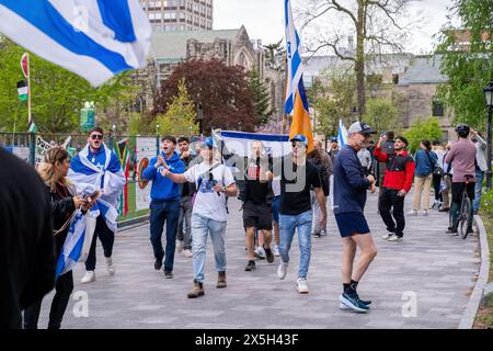 Toronto, Canada. 08th May, 2024. Pro-Israel supporters hold Israeli flags during the demonstration. Pro-Palestinian and Pro-Israel protesters at the University of Toronto outside student encampment occupying King College Circle. Advocating for Palestinian rights, students and faculty displayed banners depicting the plight of Palestinians, anti-Zionist and anti-Israel messages, while pro-Israel protests involved students and supporters in waving Israeli flags, and engaging in dialogues to defend Israel's actions and policies. Credit: SOPA Images Limited/Alamy Live News Stock Photo