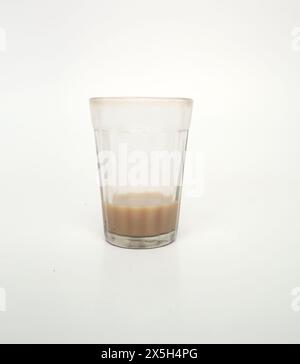 Almost empty tea glass isolated Stock Photo