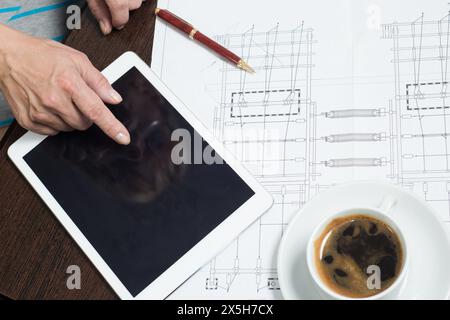 Business woman uses a tablet and graphics for the planning and analysis of market data Stock Photo