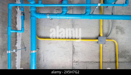 The water pipe system, wastewater pipes and electrical wiring are neatly installed under the ceiling. Stock Photo