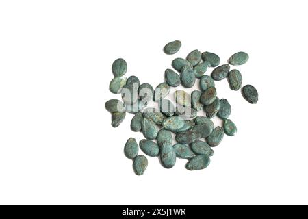 Watermelon seeds lie in a small pile on a white background, ready for planting in the garden. Stock Photo