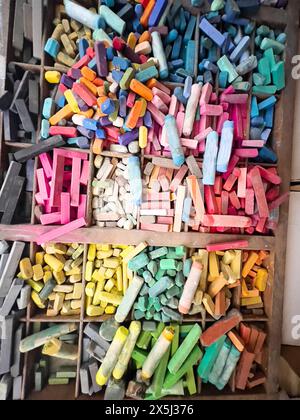 Vibrant array of used pastels in a wooden organizer Stock Photo