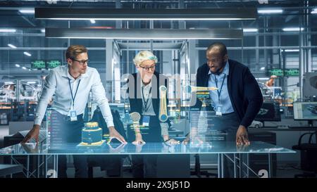 Industry 4.0 High-Tech Factory: Diverse Team of Robotics Engineers Working on Robot Arm Design, Using Augmented Reality Hologram to Manipulate 3D Model by Gestures. Engineering with Digital Technology Stock Photo