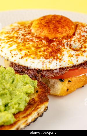 sandwich with egg, guacamole and beef patty Stock Photo
