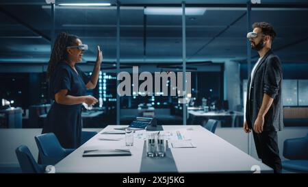 Office Online Meeting Video Conference Call: Businesswoman and Businessman Wearing Virtual Reality Glasses Talk using Augmented Reality Metaverse. Ultra Realistic Hologram of Virtual Employee Concept. Stock Photo