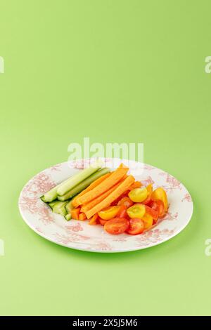 fresh vegetables on a plate. carrots, cucumbers, tomatoes Stock Photo