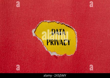 Data privacy words written on ripped red paper with yellow background. Conceptual data privacy symbol. Copy space. Stock Photo