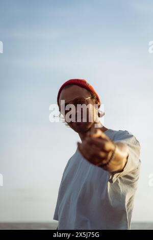 Young man in a red knitted hat. Stock Photo