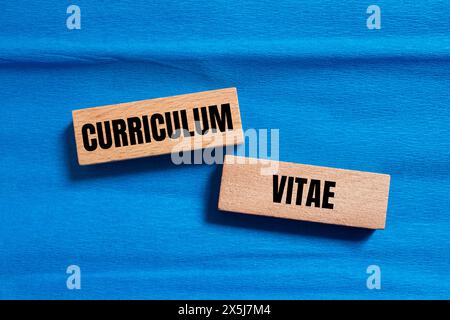 Curriculum vitae words written on wooden blocks with blue background. Conceptual curriculum vitae symbol. Copy space. Stock Photo