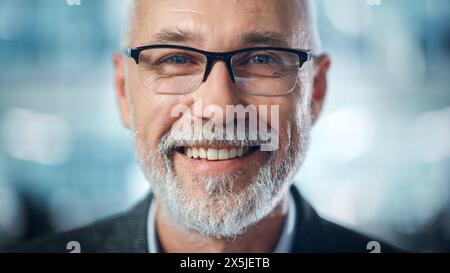 Portrait of Successful Middle Aged Bearded Man Looking at Camera and Smiling. Handsome Senior Businessman Wearing Jacket, Having Fun. Close-up Shot Stock Photo