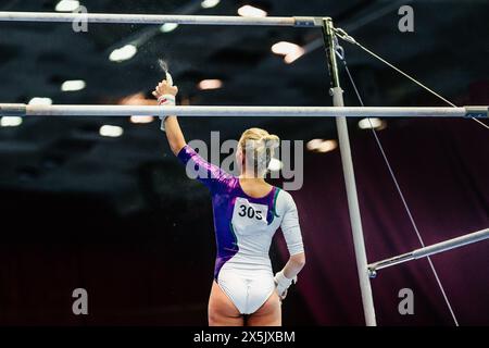 woman gymnast spraying water on uneven bars before your performance Stock Photo