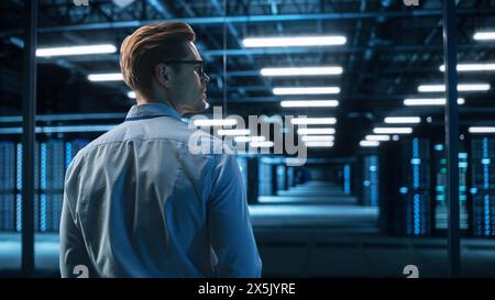 Innovative Startup Concept: View Over the Shoulder of Thoughtful Software Engineer Standing and Looking away While Thinking About Solution, Planning Strategy. Programmer Developer Concept Stock Photo