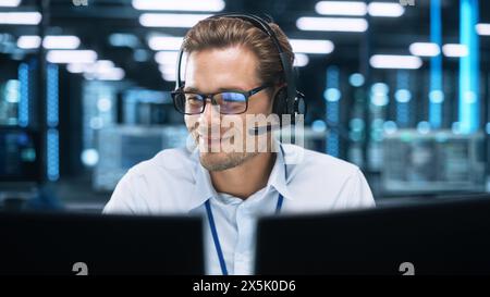 Call Center Worker Wearing Headset Working in Office to Support Remote Customer. Call Center, Telemarketing, Customer Support Agent Provide Service on Video Conference Call. Stock Photo