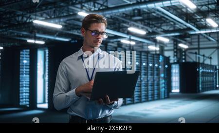 Successful Businessman in Formal Clothes Working on Laptop and Looking at the Screen in Office. Stylish male Executive Working Late on Computer to Achieve Best Results. Business Concept Stock Photo