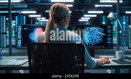 Back View of the Data Analysts Work on Visualisation with Machine Learning on Two Computer Screens in Modern Office. Data Science in Business, Finance and Innovation. Stock Photo