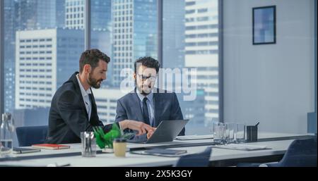 Businesspeople in Modern Office: Business Meeting of Two Businessmen Talking. CEO and Executive Director Working on Digital e-Commerce Project. Planning, Solutions, Analysis in Big City Stock Photo