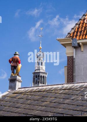 Close-up of a statue of a fisherman holding a fish on top of the roof of the former early 19th century fish market. Stock Photo