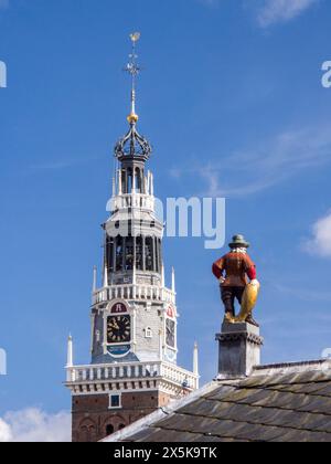 Close-up of a statue of a fisherman holding a fish on top of the roof of the former early 19th century fish market. Stock Photo