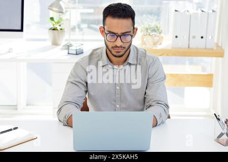 Laptop, desk and office for businessman and typing, planning and email for proposal. Computer, technology and software developer for online research Stock Photo