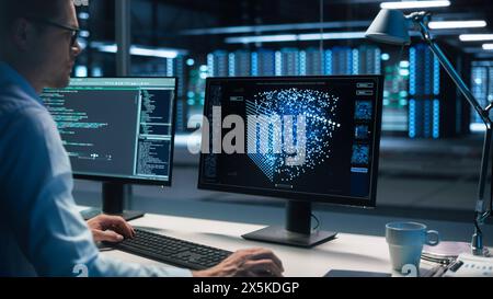 Computer Data Science Engineer Work on Desktop with Screen Showing Chart, Graph, Infographic, Technical Neural Network Data, Statistics, Programming Code with Interface. Control and Monitoring Room Stock Photo