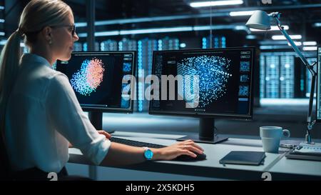 European Female Specialist Works on a Computer with Neural Network Visualisation in a Monitoring Center with Global Map Tracking on a Big Digital Screen. Big Data concept Stock Photo